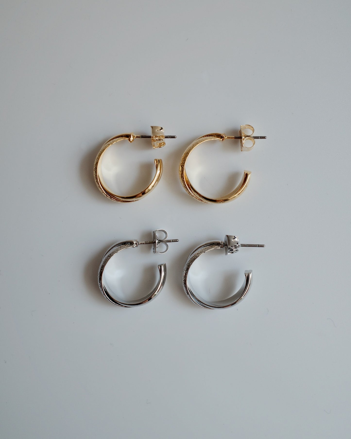 shiny cross hoop pierce