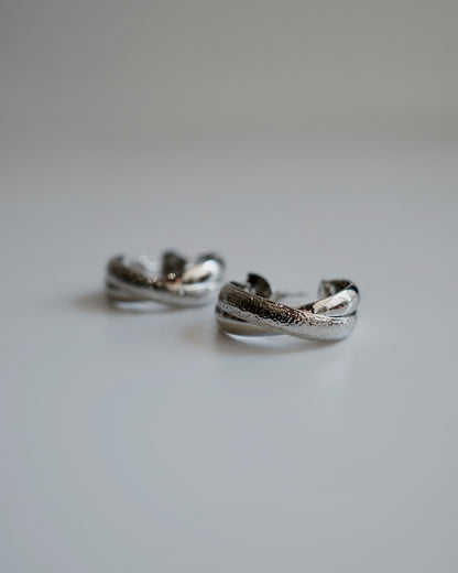 shiny cross hoop pierce